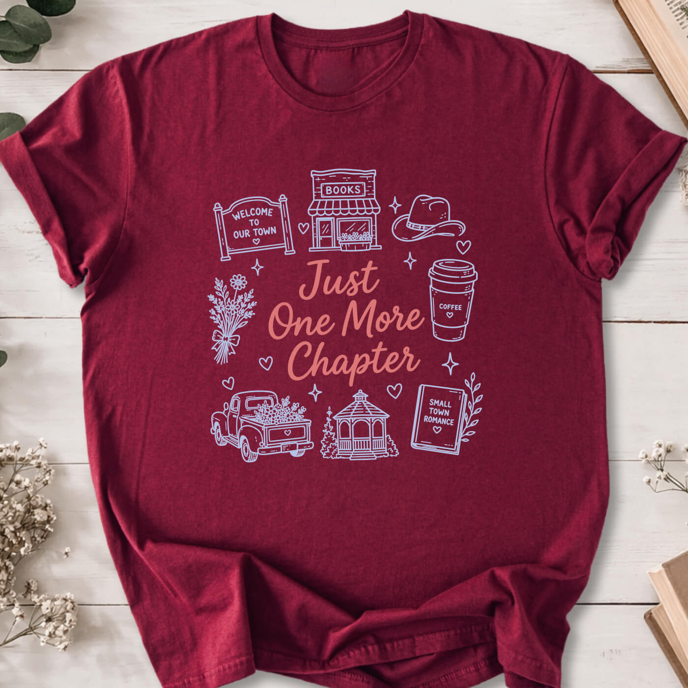 Just One More Chapter small town romance doodle t-shirt on marron Gildan 64000 with cozy romance icons.