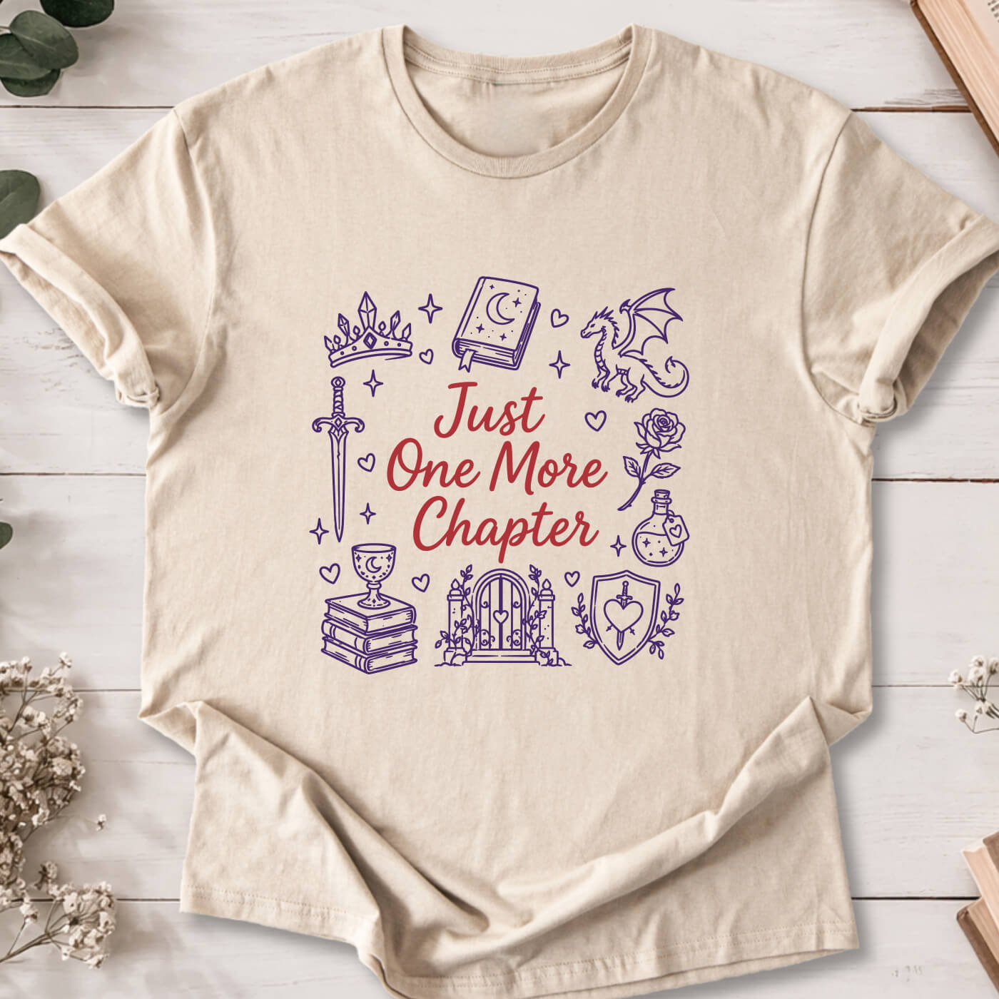 Just One More Chapter romantasy doodle t-shirt on sand Gildan 64000 with dragons, swords and fantasy icons.